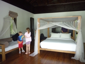 Main room of the villa: our bed and 1 of the kids' beds
